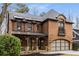 Beautiful brick home features a covered front porch with stone accents and an arched window above the garage at 2871 Parkridge Ne Dr, Brookhaven, GA 30319