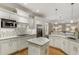 Modern white kitchen with granite countertops, stainless steel appliances, and an island with seating at 2871 Parkridge Ne Dr, Brookhaven, GA 30319