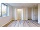 Bedroom featuring an open closet with shelving, wood-look flooring, and large window at 300 Johnson Ferry Ne Rd # B103-105, Atlanta, GA 30328