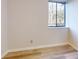 Bright bedroom with wood-look flooring, a window providing natural light, and neutral walls at 300 Johnson Ferry Ne Rd # B103, Atlanta, GA 30328