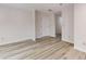 Hallway featuring clean white walls, an entrance door, and stylish wood flooring at 300 Johnson Ferry Ne Rd # B103, Atlanta, GA 30328