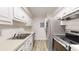 Galley kitchen featuring stainless steel appliances and light colored counters and cabinets at 300 Johnson Ferry Ne Rd # B103-105, Atlanta, GA 30328