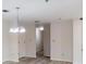 Spacious living room with dining area featuring modern lighting, neutral walls, and wood flooring throughout at 300 Johnson Ferry Ne Rd # B103-105, Atlanta, GA 30328