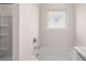 Bright bathroom with a bathtub and tiled wall at 617 Kimberwick Dr, Locust Grove, GA 30248