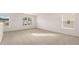 Large living room with carpeted floor, white walls, and multiple windows at 617 Kimberwick Dr, Locust Grove, GA 30248