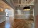 Dining room with herringbone floors, wainscoting, elegant light fixtures, and neutral colors at 1366 Wessyngton Ne Rd, Atlanta, GA 30306