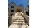 Elegant, lengthy staircase provides a grand entrance to this two-story home's covered entryway at 1366 Wessyngton Ne Rd, Atlanta, GA 30306