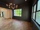 Elegant room with dark walls, decorative mouldings, beautiful wood floors, and natural light from large windows at 1366 Wessyngton Ne Rd, Atlanta, GA 30306