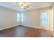 Bright bedroom features wood floors, a ceiling fan and two windows at 1492 Cobb Branch Dr, Decatur, GA 30032