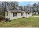 View of the side of the house with an attached garage and small yard at 1492 Cobb Branch Dr, Decatur, GA 30032