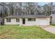Charming single-story home with a well-maintained lawn and attached single car garage at 1492 Cobb Branch Dr, Decatur, GA 30032