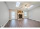 Cozy living room featuring a stone fireplace, skylights, and hardwood flooring at 1492 Cobb Branch Dr, Decatur, GA 30032