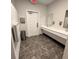 Clean bathroom with tile flooring, gray walls, and double sinks at 4541 Moray Dr, Mableton, GA 30126