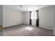 Carpeted basement featuring a bright window with curtains that allows natural light to fill the space at 70 Nw Willow Bend Dr, Cartersville, GA 30121