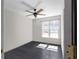 Bedroom with large window, ceiling fan, and neutral walls and flooring at 70 Nw Willow Bend Dr, Cartersville, GA 30121