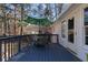 Outdoor deck featuring patio furniture and a green umbrella for shade and relaxation in your private backyard at 70 Nw Willow Bend Dr, Cartersville, GA 30121
