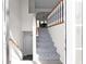 Bright foyer features a staircase with decorative carpet, white walls, and modern railing at 70 Nw Willow Bend Dr, Cartersville, GA 30121