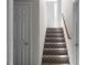 Carpeted staircase that adds comfort and style to the home, leading to the upper level at 70 Nw Willow Bend Dr, Cartersville, GA 30121