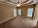 Large bedroom with a tray ceiling, ceiling fan and ample closet space at 959 Gettysburg Way, Locust Grove, GA 30248