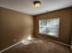 Cozy bedroom with a neutral color scheme and a well-lit window at 959 Gettysburg Way, Locust Grove, GA 30248