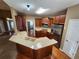 Open concept kitchen with stainless steel appliances, a breakfast bar, and ample storage at 959 Gettysburg Way, Locust Grove, GA 30248