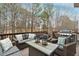 Back deck featuring an outdoor seating area with a grill and wooded backyard views at 118 Fairway Overlook Dr, Acworth, GA 30101