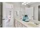 Bright bathroom featuring double sink vanity with white cabinets, large mirror, and tub/shower at 118 Fairway Overlook Dr, Acworth, GA 30101