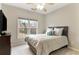 Cozy bedroom features a plush bed, TV, ceiling fan, and a large window at 118 Fairway Overlook Dr, Acworth, GA 30101