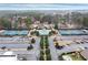 Aerial view of a grand clubhouse with symmetrical landscaping, tennis courts, and ample parking at 118 Fairway Overlook Dr, Acworth, GA 30101