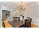 Charming dining room with a dark wood table set, chandelier, and views into the living areas at 118 Fairway Overlook Dr, Acworth, GA 30101