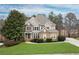 Charming two-story home with a stone and siding facade, a manicured lawn, and mature landscaping at 118 Fairway Overlook Dr, Acworth, GA 30101