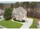 Aerial view of a two-story home with brick and siding, a well-manicured lawn, and a spacious driveway at 118 Fairway Overlook Dr, Acworth, GA 30101