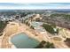 Aerial view of a stunning golf course community with a clubhouse, pond, and lush greenery at 118 Fairway Overlook Dr, Acworth, GA 30101