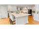 Bright kitchen featuring a large center island with seating, white cabinetry, and hardwood floors at 118 Fairway Overlook Dr, Acworth, GA 30101