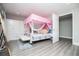 Bedroom featuring a canopy bed, white wardrobe, and gray wood floors at 185 Whetstone Way, Villa Rica, GA 30180