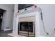 Close-up of the elegant white fireplace with a screen and mounted television at 185 Whetstone Way, Villa Rica, GA 30180