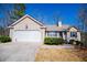 Attractive one-story home with a well-manicured lawn and an attached two-car garage at 185 Whetstone Way, Villa Rica, GA 30180