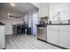 Bright kitchen with stainless steel appliances, granite countertops, and gray vinyl flooring at 185 Whetstone Way, Villa Rica, GA 30180