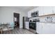 Kitchen with stainless steel appliances, white cabinets, subway backsplash, and eat-in area at 185 Whetstone Way, Villa Rica, GA 30180