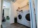 Functional laundry room with modern washer and dryer, and convenient shelving at 185 Whetstone Way, Villa Rica, GA 30180