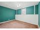 Bedroom with blue walls and a window for natural light at 2248 Bethel Rd, Conyers, GA 30012