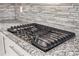 Modern cooktop features a stainless steel finish and granite countertops at 2760 Swansea Ct, College Park, GA 30349