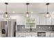 The kitchen has modern pendant lights and stainless steel appliances at 2760 Swansea Ct, College Park, GA 30349