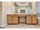 Bathroom featuring double vanity with wood cabinets and large mirror at 2790 Laurel Valley Trl, Buford, GA 30519