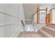 Traditional staircase with carpeted steps, a decorative railing, and white trim at 2790 Laurel Valley Trl, Buford, GA 30519