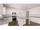 Modern kitchen with granite countertops, white cabinets, and stainless steel appliances at 629 Kimberwick Dr, Locust Grove, GA 30248