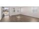 Sunlit living room with wood floors, showcasing windows and an open doorway at 629 Kimberwick Dr, Locust Grove, GA 30248