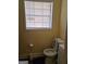 Compact bathroom with a toilet, updated fixtures, and bright window at 3551 Northgate Cv, Ellenwood, GA 30294