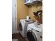 Convenient laundry room with a washer, dryer, and storage shelves at 3551 Northgate Cv, Ellenwood, GA 30294