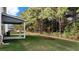 Green backyard featuring a covered patio area surrounded by trees at 633 Kimberwick Dr, Locust Grove, GA 30248